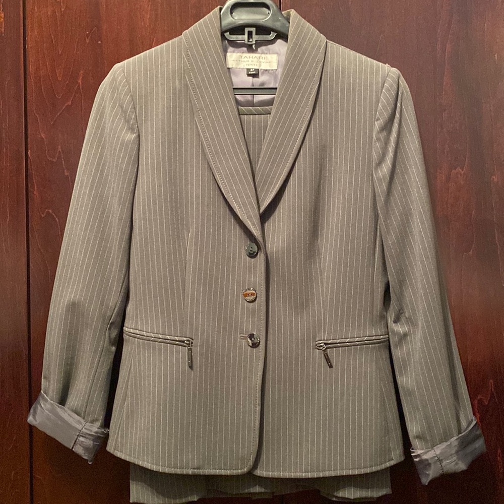 Two piece Grey Suit/ jacket and above knee skirt from Tahari. Brand new.